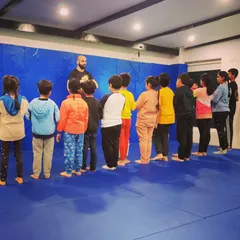 Lining up and listening. Respect and discipline are core to what we do, and it starts from the moment they step on the mat. This is a key part of their martial arts journey.