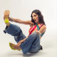 A playful, high-energy shot from a recent photoshoot. The bright neon heels and dynamic pose capture my personality perfectly.