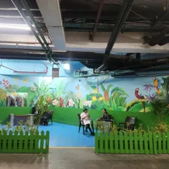 A wide view of our jungle-themed mural in a designated smoking area at the Leela Ambience Hotel. The vibrant artwork turns a functional space into a tropical oasis.