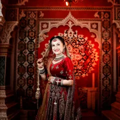 This bride's happy smile lights up the frame. I captured this against a richly decorated backdrop, making the red of her lehenga even more vibrant.