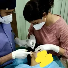 A core part of my professional life is teaching and mentoring the next generation of dermatologists. Here, I am guiding a hands-on session, because practical skill and expert supervision are the bedrock of safe medical practice.