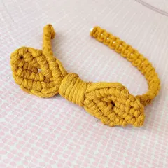I made this cute macrame bow hairband for a client's daughter. It's a unique, knotted accessory that is both playful and stylish for little ones.
