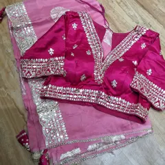 This blouse and saree set in shades of pink showcases beautiful gota patti and mirror work. I work closely with you to ensure the blouse design, from the neckline to the sleeve details, is exactly what you envision.