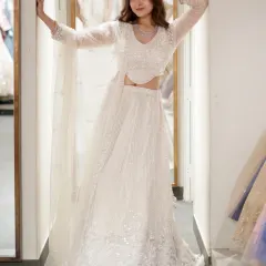 Wearing what moonlight would look like if it were an outfit. A full shot of the ethereal white sequin lehenga, perfect for a reception or engagement party.