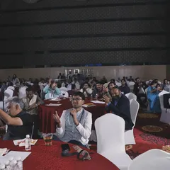 A wide shot of the audience during a corporate event. You can see a mix of applause, laughter, and focused attention. This is the energy I strive to create in every room.