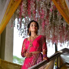 A stunning, artistic shot of Tanu on the stairs, with the light catching her joyful expression and gorgeous pink outfit.
