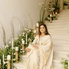 The guest of honor enjoying the elegant decor at her milestone birthday party. We lined the stairs with a mix of fresh florals and candles at varying heights to make the entire space feel special and celebratory.
