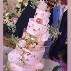 My first five-tier cake! This magical white and gold creation was for a 25th anniversary. It featured floating tiers with lights, delicate gold leaf, and a cascade of white roses. The top tiers were chocolate mousse and the bottom was classic pineapple.