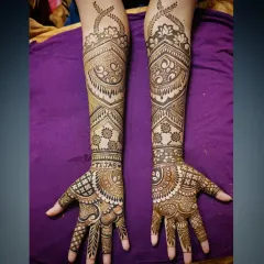 This is an example of my intricate full-arm mehandi work. The design features a mix of delicate paisleys, bold geometric bands, and fine line work, creating a stunning and balanced look perfect for any grand celebration.