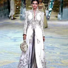 On the runway for the Manish Malhotra Bridal Couture Show. This look features glowing skin and defined eyes, designed to be impactful from a distance and under bright runway lights.