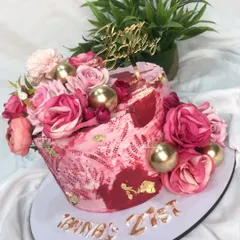 A floral cake in shades of hot pink with gold stenciling for a 21st birthday. The vibrant colors and textures create a bold and beautiful statement piece.