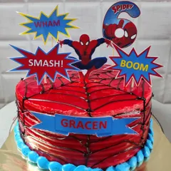 An action-packed Spider-Man cake for a 6th birthday. This design features a glossy red web effect and comic book style toppers for your little superhero.