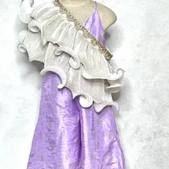 A modern take on festive wear. This lavender jumpsuit features a stunning, sculptural white frill that drapes over the shoulder, creating a high-fashion ethnic look.