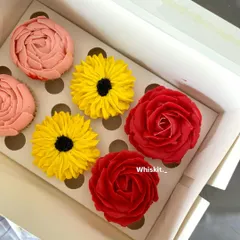 Another angle of my beautiful floral cupcakes. The vibrant colors and intricate piping work make these a standout addition to any celebration.