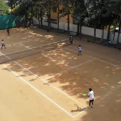 An overhead view of our facility showing multiple courts in use. This perspective showcases the ample space and active community you can join, whether for a casual weekend game or regular group play.