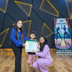 A young camper receives his certificate and trophy. These moments are what make the camp so rewarding, boosting a child's self-esteem and leaving them with a tangible reminder of their achievements.