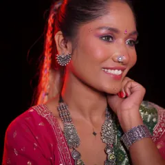A closer look at the finished makeup from our professional course. Notice the blended eyeshadow, detailed jewelry, and radiant smile, all part of the final portfolio shot for the student.