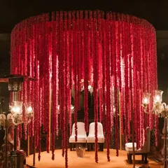This stunning wedding mandap at the Oberoi Amarvilas in Agra was defined by elegance. A cascade of red florals created a dramatic and romantic canopy for the couple to exchange their vows.