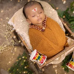 A newborn styled as a tiny Lord Shiva, complete with a tripundra on the forehead and rudraksha beads. This divine-themed newborn shoot is a unique way to celebrate your baby's arrival.
