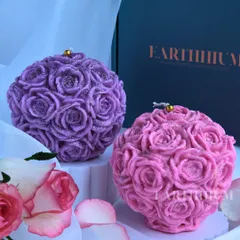 My rose ball candles are like a bouquet that never fades. This image shows the purple and pink versions, each covered in tiny, detailed roses with a hint of glitter.