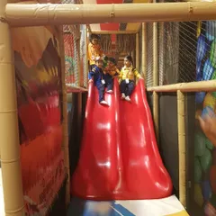 A train of friends heading down the big red slide. Our structures are perfect for group play, allowing kids to enjoy the fun together.