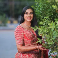 A candid moment from her reception photoshoot. The makeup looks fresh and beautiful in natural evening light.