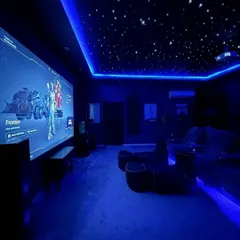For the ultimate gaming experience, I designed this gaming sanctuary. It features a massive projector screen for total immersion, a starlit fiber optic ceiling, and dynamic RGB lighting that syncs with the gameplay. This setup, powered by a high-performance audio system, is built for competitive and cinematic gaming on platforms like PS5 and Xbox.