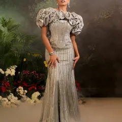 My Bellerose Gown in a shimmering silver, featuring a dramatic 3D floral cape. I designed this piece to be a wearable work of art, blending intricate embellishment with a bold, sculptural silhouette.