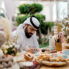 We love incorporating local culture into our destination weddings. Here, a calligrapher creates personalized art for guests at our 'Markets of the Middle East' event in Doha.