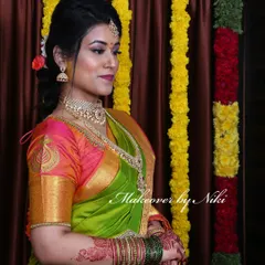 Nirosha looking absolutely radiant for her engagement. We went with a classic South Indian look, featuring a defined eye, a warm lip color, and a simple updo that perfectly complemented her green and pink silk saree.