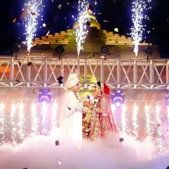 Anmol and Deepali's varmala moment, enveloped in a cloud of smoke and sparkling pyrotechnics. We use special effects to elevate key moments, making them feel truly magical and cinematic.
