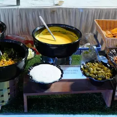 Our interactive "Build your Own Burrito Bowl" station. Guests can customize their bowls with a variety of fresh vegetarian fillings, cheese sauce, salsa, and sour cream for a personalized taste of Mexico.