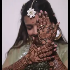 A lovely and shy pose from a member of the bridal party. Her hands feature a dense floral pattern that is both festive and elegant.