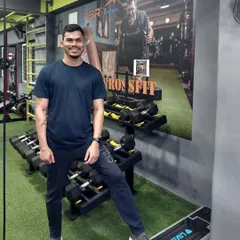 A photo of me in my element at the Akhada. Our gym is fully equipped with everything we need, from dumbbell racks to a CrossFit setup.