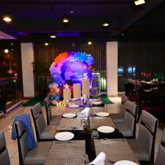 This photo shows how my birthday decorations fit into a restaurant setting. The space-themed setup is placed at the end of the dining area, creating a dedicated party zone without disrupting the restaurant's layout.