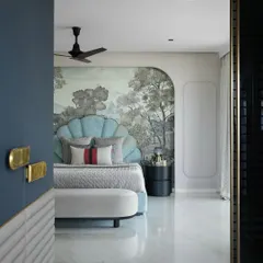 The daughter's bedroom in the same South Bombay home is both bold and stylish. A statement shell-shaped headboard in light blue is set against a beautiful custom wallpaper, creating a whimsical and personal space.