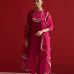 A stunning magenta suit with an elegantly embroidered dupatta. The embroidery is placed strategically along the border and as a necklace-like pattern, creating a cohesive and regal look.