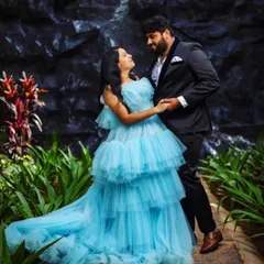 This is the dress that makes you feel like you're in a real-life Cinderella story. My client looks absolutely radiant in this sky blue tiered ruffle gown, perfectly complemented by her partner's classic black suit.