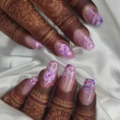 A closer look at the details on this custom bridal set. The combination of glitter, hand-lettering, and abstract designs makes for a truly personal and memorable manicure for the big day.