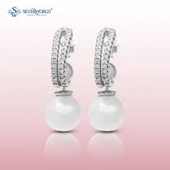 A modern take on pearl earrings, this pair features a classic pearl drop suspended from a zirconia-encrusted huggie hoop. It's the perfect blend of classic and contemporary.