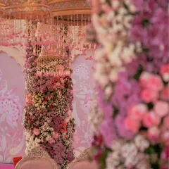 A mandap designed to feel like a blooming garden, with towering columns of pastel flowers. This close-up shows the sheer density and variety of florals used to create this whimsical, romantic effect.