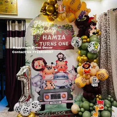 A first birthday is a special milestone, and my jungle safari theme is a client favorite. This home decor setup includes a custom backdrop with cute animals, a balloon garland in jungle colors, and a foil number '1' balloon.