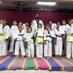 A proud group of our female students on stage after receiving their new belts. Their achievements highlight the growing strength of women in Taekwondo.