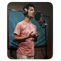 Once the lyrics and melody are set, I head into the booth to record the vocals. This photo shows me during a recording session, focusing on delivering a performance that carries the right emotion for the song.