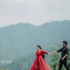 Color theory is key to making your subjects pop. Learn how we use a vibrant red dress against the muted greens and blues of the Himalayan foothills to create a visually striking image. The leading line of the couple's arms draws the viewer's eye across the frame.