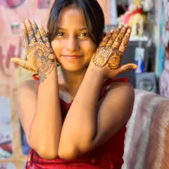 A happy client showing her beautiful, intricate mehndi. This is a typical design I create for wedding guests who want something special for the occasion.