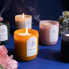 My scented luxury candles are designed to create a multi-sensory experience that helps you relax and unwind. This image captures the soothing glow of my frosted jar collection, surrounded by flowers to highlight their nature-inspired fragrances.