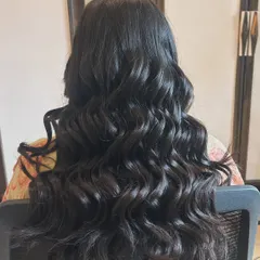 A full view of classic, voluminous curls. This timeless hairstyle is perfect for any special occasion, adding glamour and movement.