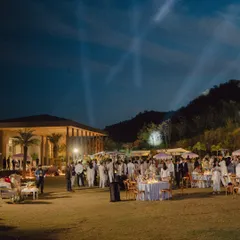 The magical atmosphere of Mouli and Jaymit's outdoor reception in Udaipur, with spotlights lighting up the night sky.