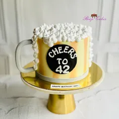 Cheers to 42. A fun beer mug-themed birthday cake, complete with frothy whipped cream foam, to celebrate in style.